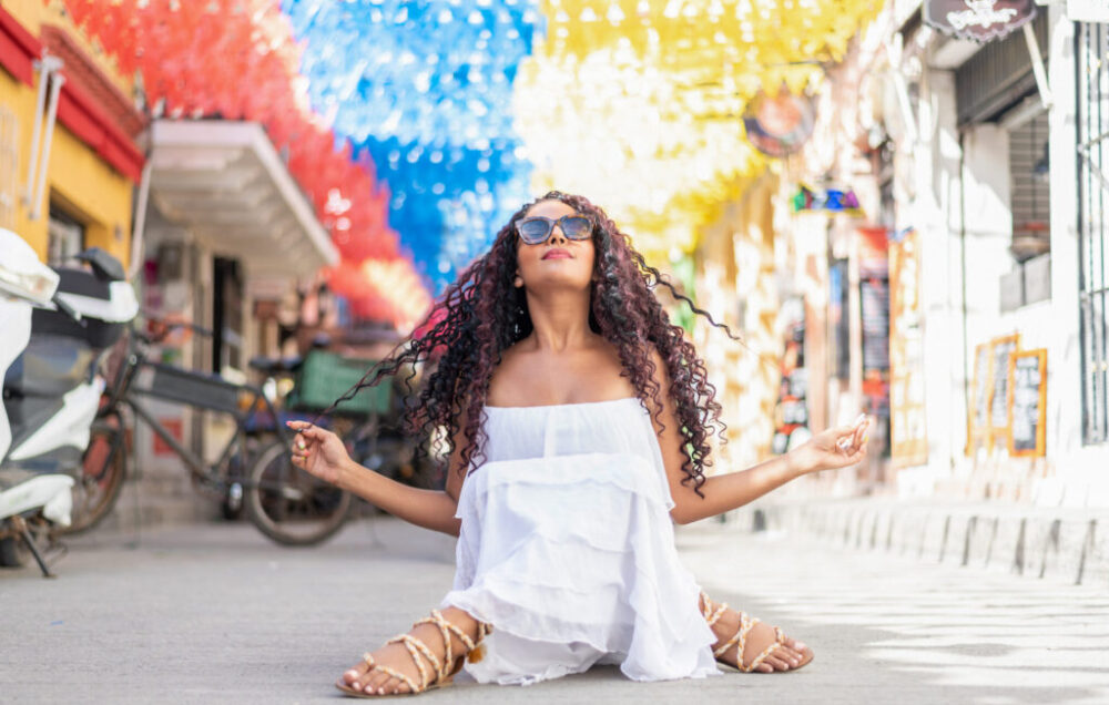 Beautiful local Colombian woman in white dress in the walled city of Cartagena, Colombia