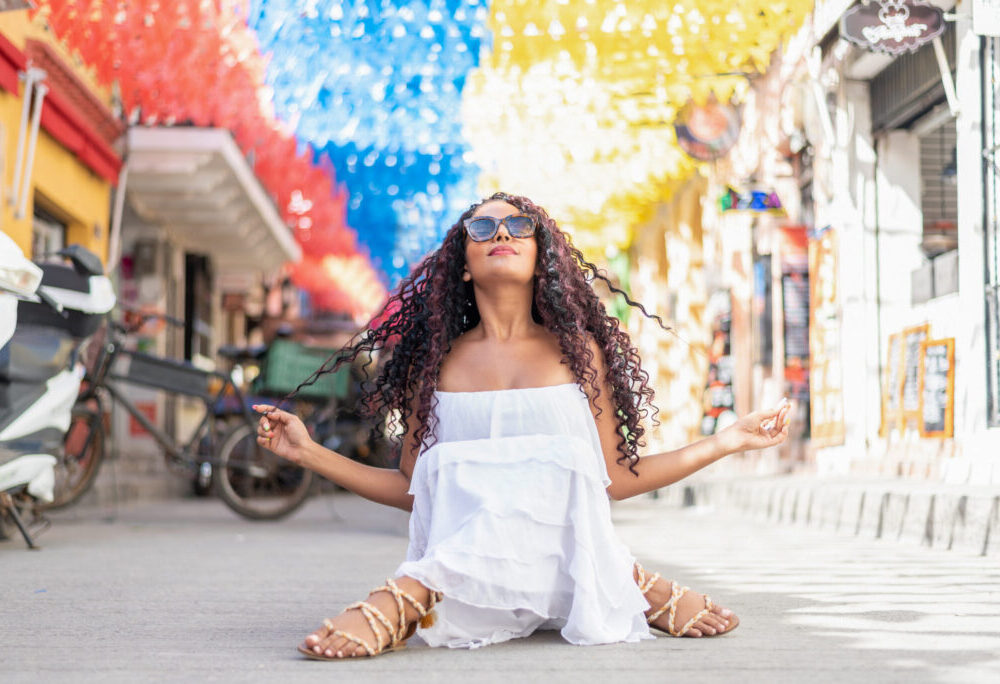 Beautiful local Colombian woman in white dress in the walled city of Cartagena, Colombia